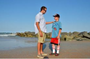 PETER.WILLOTT@STAUGUSTINE.COM Dustan Doucette talks with Austin Wesp, 12, near the Vilano Beach jetty on Wednesday, May 21, 2014. Doucette saved Wesp after a rip tide pulled him far out into the ocean on May 15.